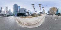 the view from a skate boarder going up a ramp in a downtown street looking down a city street