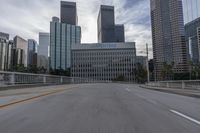 empty road going past skyscrapers on a sunny day in the city of los, california