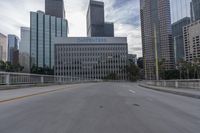 empty road going past skyscrapers on a sunny day in the city of los, california