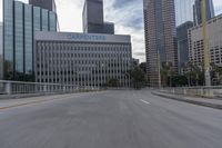 empty road going past skyscrapers on a sunny day in the city of los, california