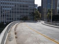 a city street is deserted with an empty walkway next to it and skyscrapers in the background