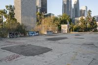 this empty lot is very dirty and not clear from any graffiti on the ground and the trees that are very tall are tall