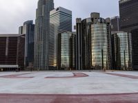 a view of some high rise buildings and a concrete walkway with white paint on them