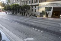 a street in the middle of downtown san francisco, california is empty with vehicles on it