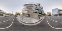 a blurred image of a street and buildings in the background with the street showing two sides with the road closed,