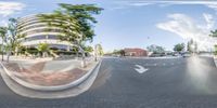 a fisheye picture taken from the camera point of view of a street intersection with buildings in the background