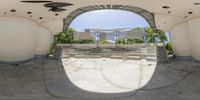 a view out of a wide open roof with a small circular mirror on it of the inside