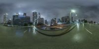 a street scene with buildings and buildings in the background at night time with an inverted lens