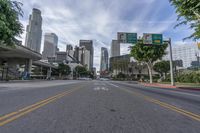 an empty street with multiple signs that say go ahead and bicycle path with buildings in the background