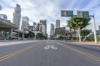 an empty street with multiple signs that say go ahead and bicycle path with buildings in the background