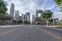 an empty street with multiple signs that say go ahead and bicycle path with buildings in the background