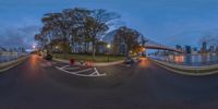 an intersection has a car and bike on it in front of a bridge, a view of a city