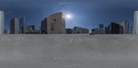 the view of a downtown city from a concrete ramp in a parking lot at the edge of town