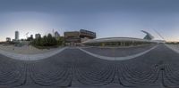 the reflection of the building in the middle is seen through the circular shaped lens in this panoramic shot