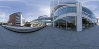 a person is walking on a cement walkway with a large fish eye view lens in the background