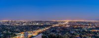 an aerial photo of the city lights of downtown san diego at night time with traffic driving along it