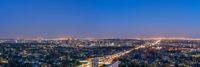 an aerial photo of the city lights of downtown san diego at night time with traffic driving along it