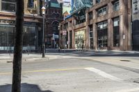 an empty intersection in an old downtown area of city life with tall buildings along the side