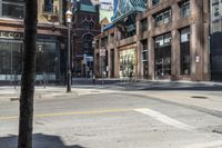 an empty intersection in an old downtown area of city life with tall buildings along the side