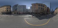 a person walking down the sidewalk in a busy city street, and a picture taken with a fish eye lens