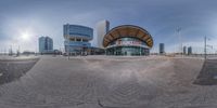 a photo of a building and car park from a fish eye view lensed in front of it