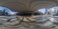 an image of a street corner in the city with skyscrapers in the background while the 360 lens is used