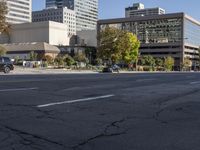 a city with a road and traffic light sitting in the middle of it next to buildings