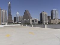 the view over the downtown area of a parking lot with an empty parking lot to the side