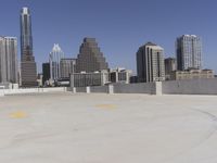 the view over the downtown area of a parking lot with an empty parking lot to the side