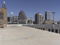 the view over the downtown area of a parking lot with an empty parking lot to the side