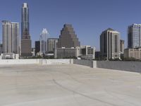 the view over the downtown area of a parking lot with an empty parking lot to the side