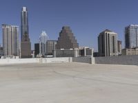 the view over the downtown area of a parking lot with an empty parking lot to the side