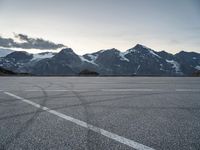 a snow covered mountain range with mountains in the distance and lines in the middle of it