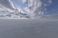 the sky with white clouds and a cloud is visible in the snow with snow patches