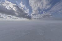 the sky with white clouds and a cloud is visible in the snow with snow patches