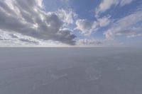 the sky with white clouds and a cloud is visible in the snow with snow patches