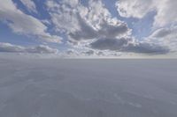 the sky with white clouds and a cloud is visible in the snow with snow patches