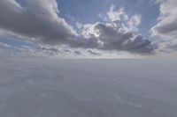 the sky with white clouds and a cloud is visible in the snow with snow patches