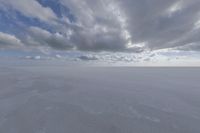 the sky with white clouds and a cloud is visible in the snow with snow patches