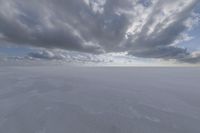 the sky with white clouds and a cloud is visible in the snow with snow patches