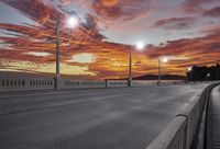 this is a scenic view of an empty highway at sunset time with street lamps on either side of the road