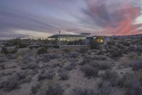 the sun is setting behind this desert house in arizona's mojave desert