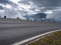 this is an image of a motorcyclist riding on the road on a cloudy day