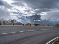 this is an image of a motorcyclist riding on the road on a cloudy day