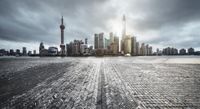 black and white image of a skyline in shanghai, china taken from across the water