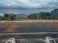 two broken down boats sit on the road with buildings in the background along a street