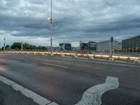 an image of a empty street in the evening time with lights on it's sides