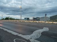 an image of a empty street in the evening time with lights on it's sides