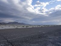 a picture of a desert scene on an empty road from the perspective angle of a vehicle