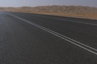 Dramatic Scenery in the UAE: Desert Road Leading to Mountains